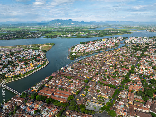 Top down aerial image of boats moored along the Thu Bon River waterfront in Hoi An.