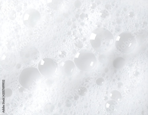 Close-up view of a frothy, white soap suds.  Bubbles of various sizes are visible