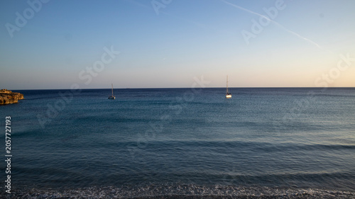 Two Sailboats on Calm Blue Ocean Water with Gentle Waves