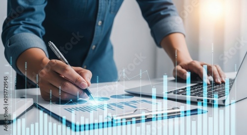 Businessperson analyzing data on laptop with graphs and charts overlay on documents