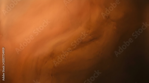 Abstract swirling textures of warm earth tones and deep shadows create a captivating organic pattern resembling natural forms of mineral deposits or distant cosmic nebulae for artistic or
