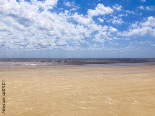 Beach Sand with Ocean and Clouds
