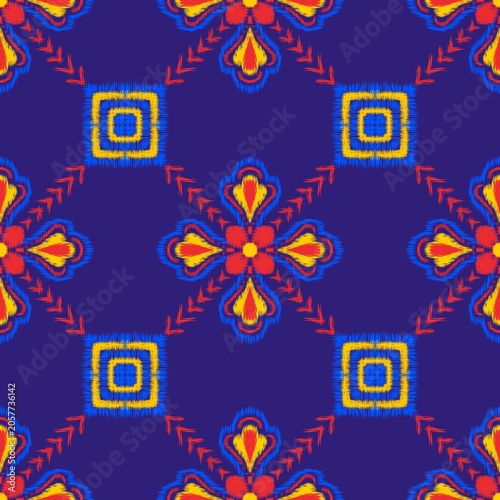 Vibrant Ikat Seamless Pattern with Colorful Tribal Geometric Motifs on Deep Blue Background