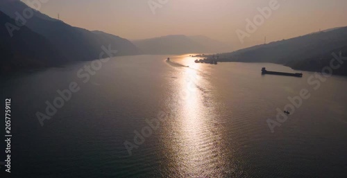Aerial Sunset View of Cargo Boats on a Mountain River Valley