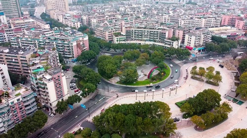 Aerial view of urban roundabout with residential buildings and traffic