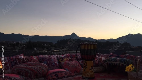 Colorful Rooftop Lounge with Drum and Mountain Sunset View