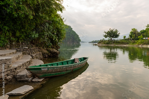 Pokhara, Nepal - April 19th 2015 - A scenic view of the shores of Phewa Lake in Pokhara around sunset.