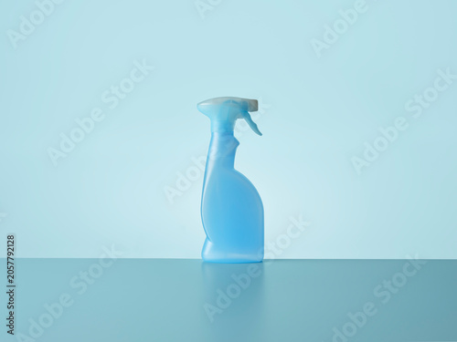 Blue trigger spray against blue background with horizon