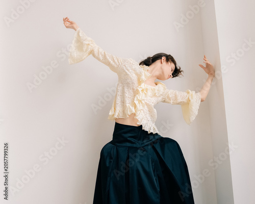 Dramatic editorial movement in ivory lace and black skirt