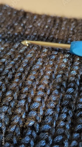 Blue textured crocheted fabric with chunky yarn with  crochet hook 4mm, handmade intricate stitch patterns close-up