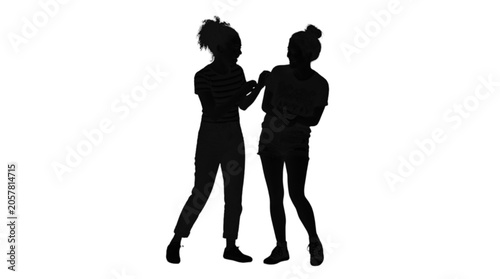 Two silhouetted people hugging and embracing warmly