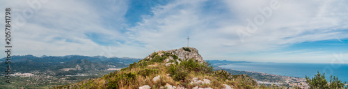 Panoramic view to the mountains with a cross on the peak, in Montgo, Dénia, Comunidad Valenciana, Spain. 