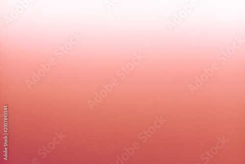 Abstract soft gradient background in shades of coral pink and white. Smooth blurred texture for minimalist graphic design, web banners, and modern presentation backdrops.
