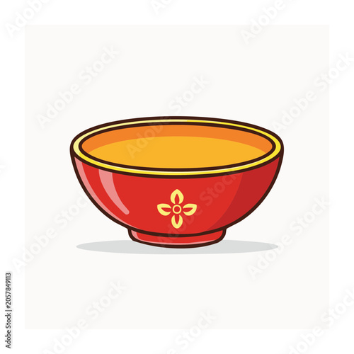 Red bowl with orange soup and spoon
