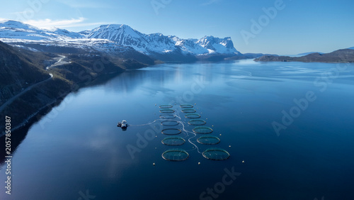 Calm sea on the fjord near Sorkjosen,Troms County Norway. Fish farm in the evening light 
