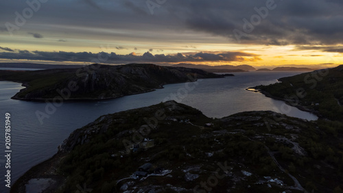 drone shot of midnight sun over Bokfjord near Ropelv in South Varanger, Northern Norway