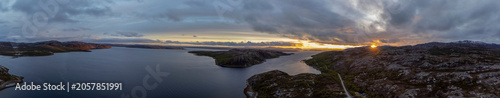 Panoramic drone shot of midnight sun over Bokfjord near Ropelv in South Varanger, Northern Norway