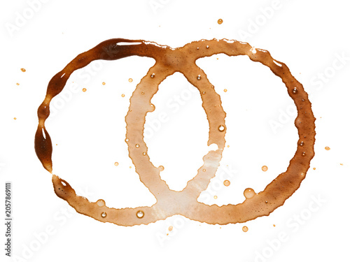 Coffee ring stain on white surface with irregular shape, dark brown and light brown colored ring, and splatter for abstract design or stain pattern background