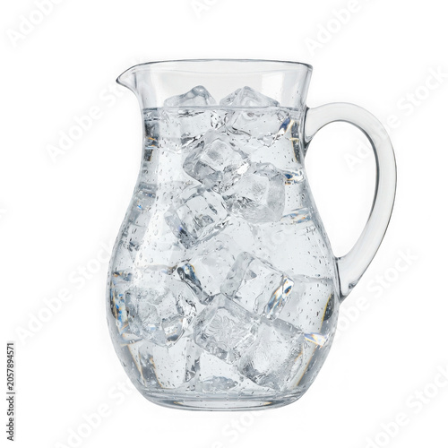 Glass pitcher filled with fresh water and ice cubes for summer drinks