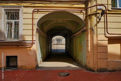 Passage through an arch in the courtyard of a house in the city of St. Petersburg