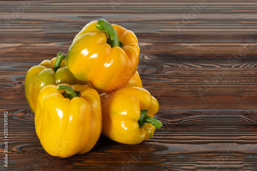 Canvas Print Fresh homegrown sweet peppers arranged on wooden surface