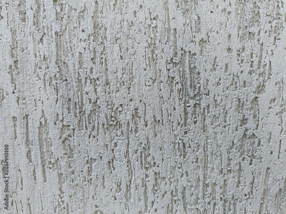 Fototapeta premium Rough textured stucco wall background with vertical grooves. Abstract grey plaster facade pattern.