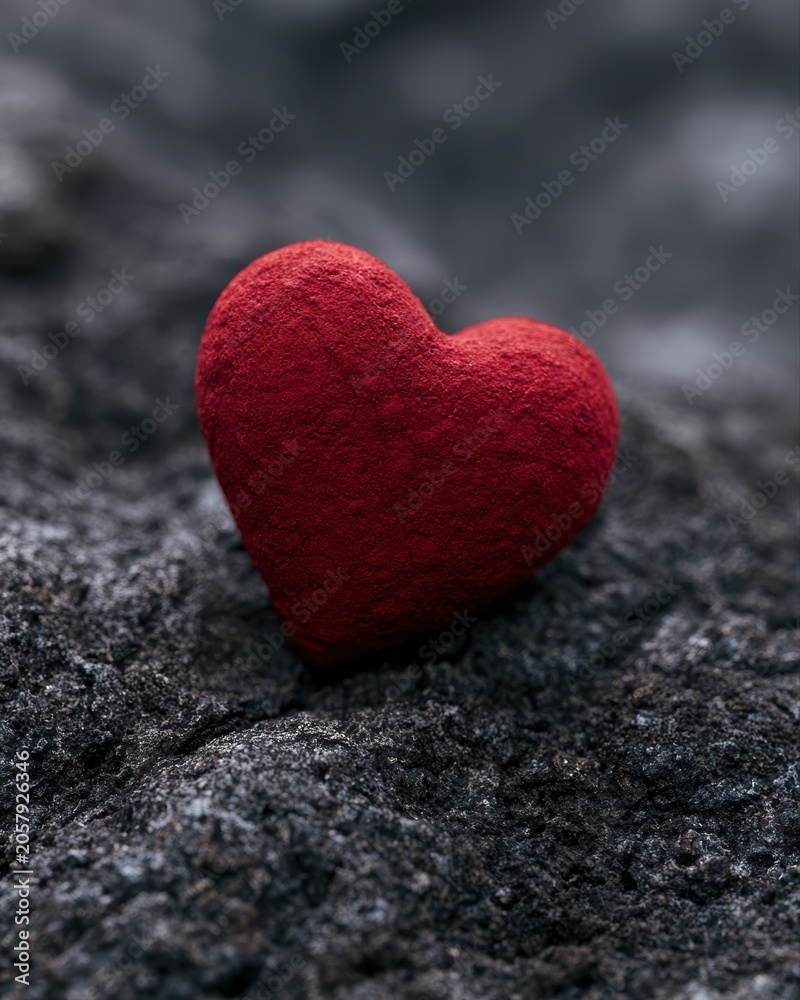 Obraz premium red heart placed on stone surface, love yourself first concept, warm cinematic lighting