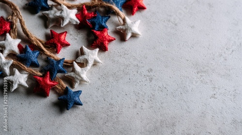 Flat lay of patriotic red, white, and blue star-shaped decorations on gray background