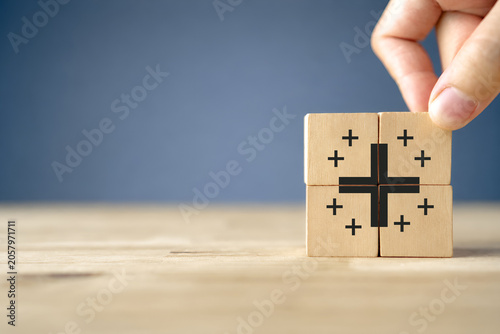Positive things; added value, benefits, additional, personal development, growth mindset, positive thinking, opportunities, emerging market. Putting the cubes with plus sign to offer positive things.
