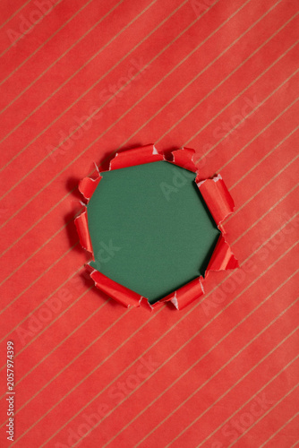 Gift wrapping paper tears from the center on a green background. Layout for discounts, text, etc
