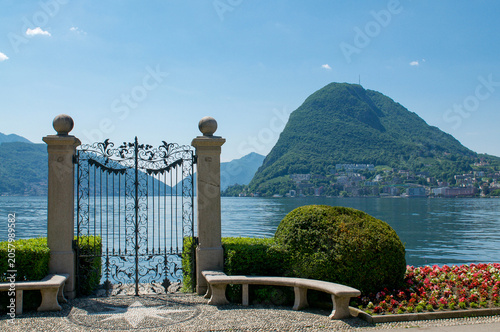 Iron gate of Parco Ciani opening on Lake Lugano and Monte San Salvatore