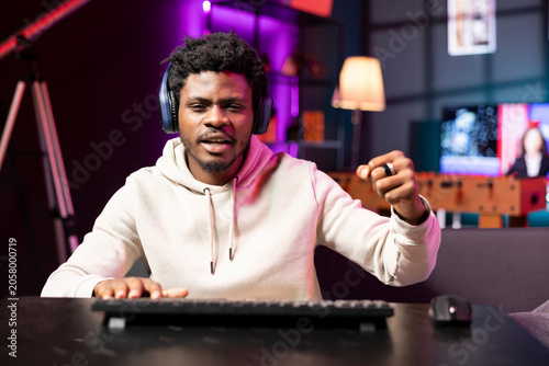 Billede på lærred Cheerful gamer feeling excited after finally defeating all enemies while playing on computer