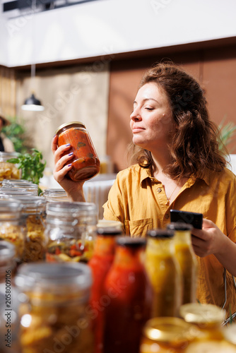 Bilde på lerret Green living client in zero waste store using smartphone notes app to check shopping list while meticulous customer looking to replenish pantry at home with nutritious additives free food essentials