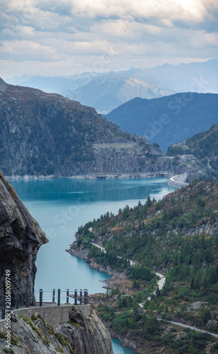 Scenic view of Lake Emosson and hydroelectric dam surrounded by rugged mountains and turquoise water in the Swiss Alps, Valais, Switzerland