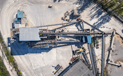 Top down aerial view of aggregate processing plant with conveyor systems and industrial infrastructure in Southern France