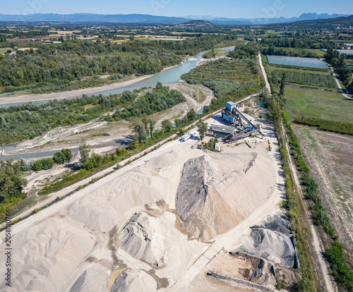 Aerial view of aggregate processing plant with conveyor systems, industrial machinery and mineral processing infrastructure operating within a quarry extraction site in Southern France