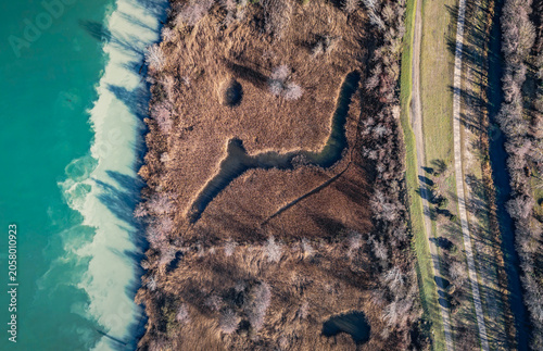 Abstract aerial pattern of wetlands and turquoise water along the Rhone River in France