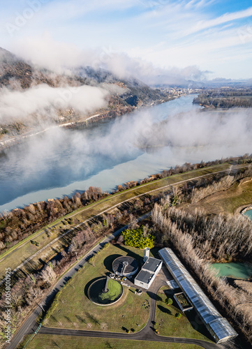 Aerial view of wastewater treatment plant along the Rhone River on a misty morning in Southern France