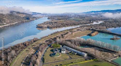 Aerial view of wastewater treatment plant along the Rhone River on a misty morning in Southern France