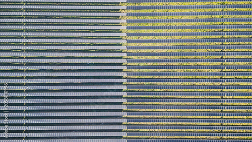 Top down aerial view of solar photovoltaic panels forming geometric pattern at renewable energy farm