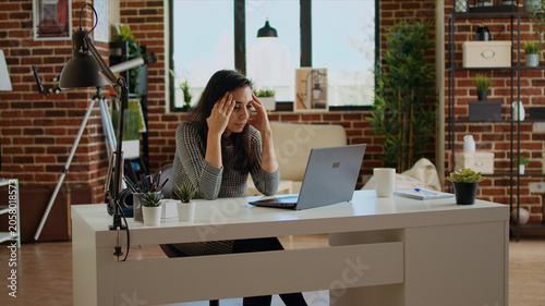Εκτύπωση καμβά Stressed overworked indian employee struggling to concentrate while working from home, hurting from headache