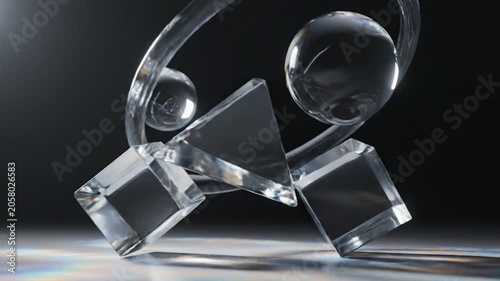 Abstract glass geometric shapes balancing on a reflective surface