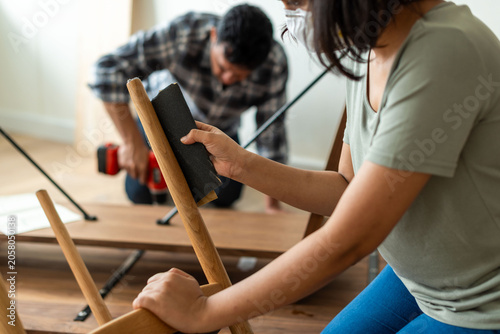 Photography Couple assembling wooden furniture together