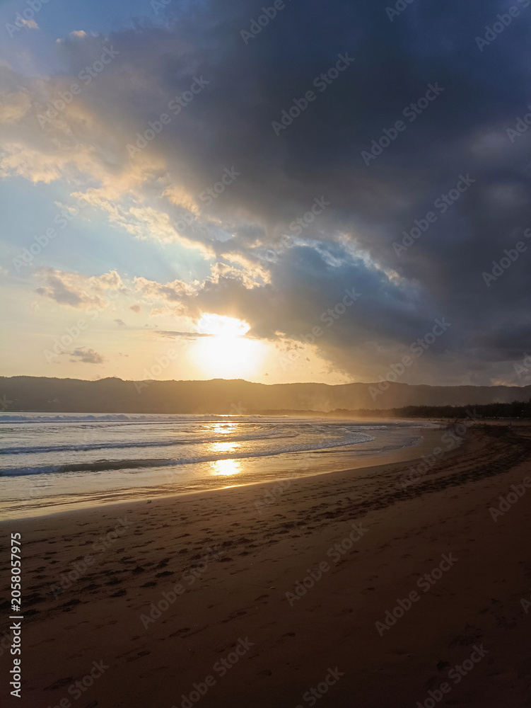 Fototapeta premium Tropical Seaside Sunset with Dramatic Sky and Ocean Reflection
