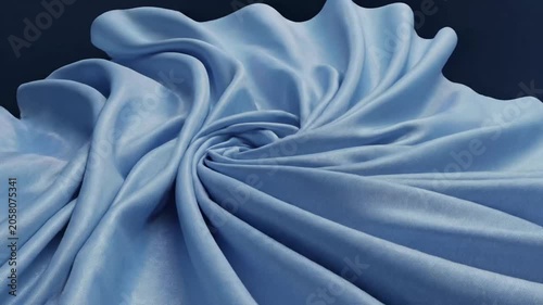 Flowing blue silk fabric floating on dark blue background