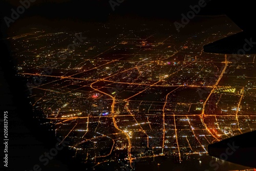 Night view Airplane Window of Shanghai, China Aerial Cityscape Above the Clouds