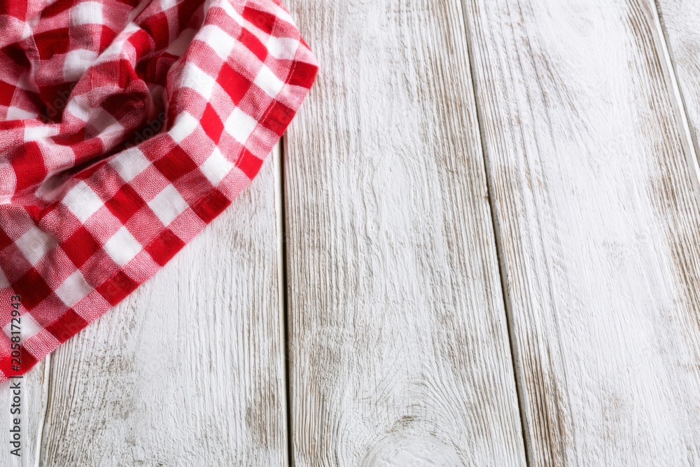 Obraz premium Red checkered cloth on white wooden table with rustic copy space