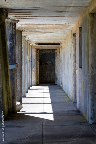 Abandoned Concrete Corridor with Dramatic Light and Shadows