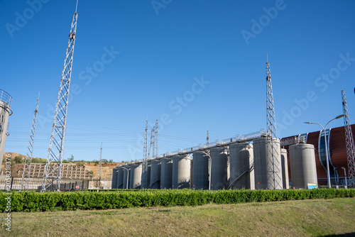 фотографія Industrial facility with large cylindrical storage tanks and metal towers