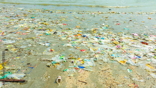 Photography Polluted beach with plastic waste and garbage washed up on the shore, environmen